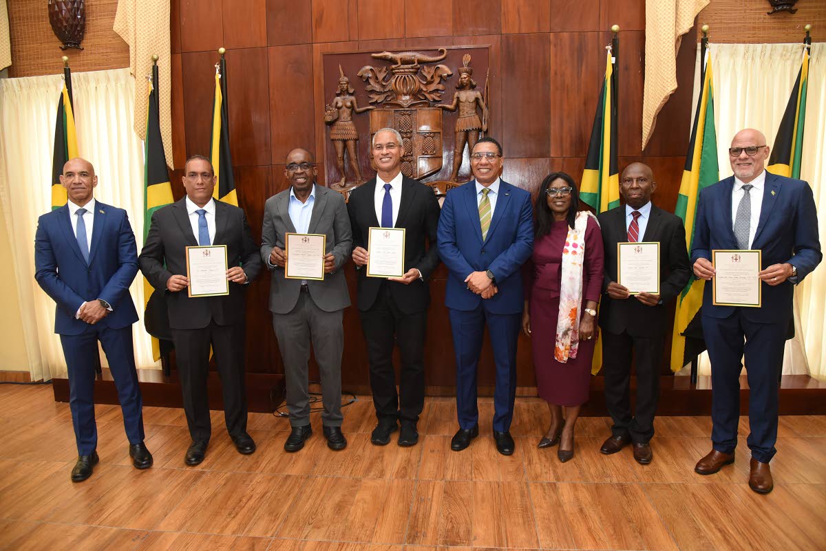 Prime Minister Dr. Andrew Holness (fourth right), Audrey Sewell (third right), Cabinet Secretary, Ambassador Antony Anderson (left), Chief Executive Officer, National Reconstruction and Resilience Authority (NARRA), share a moment with members of the Jamai