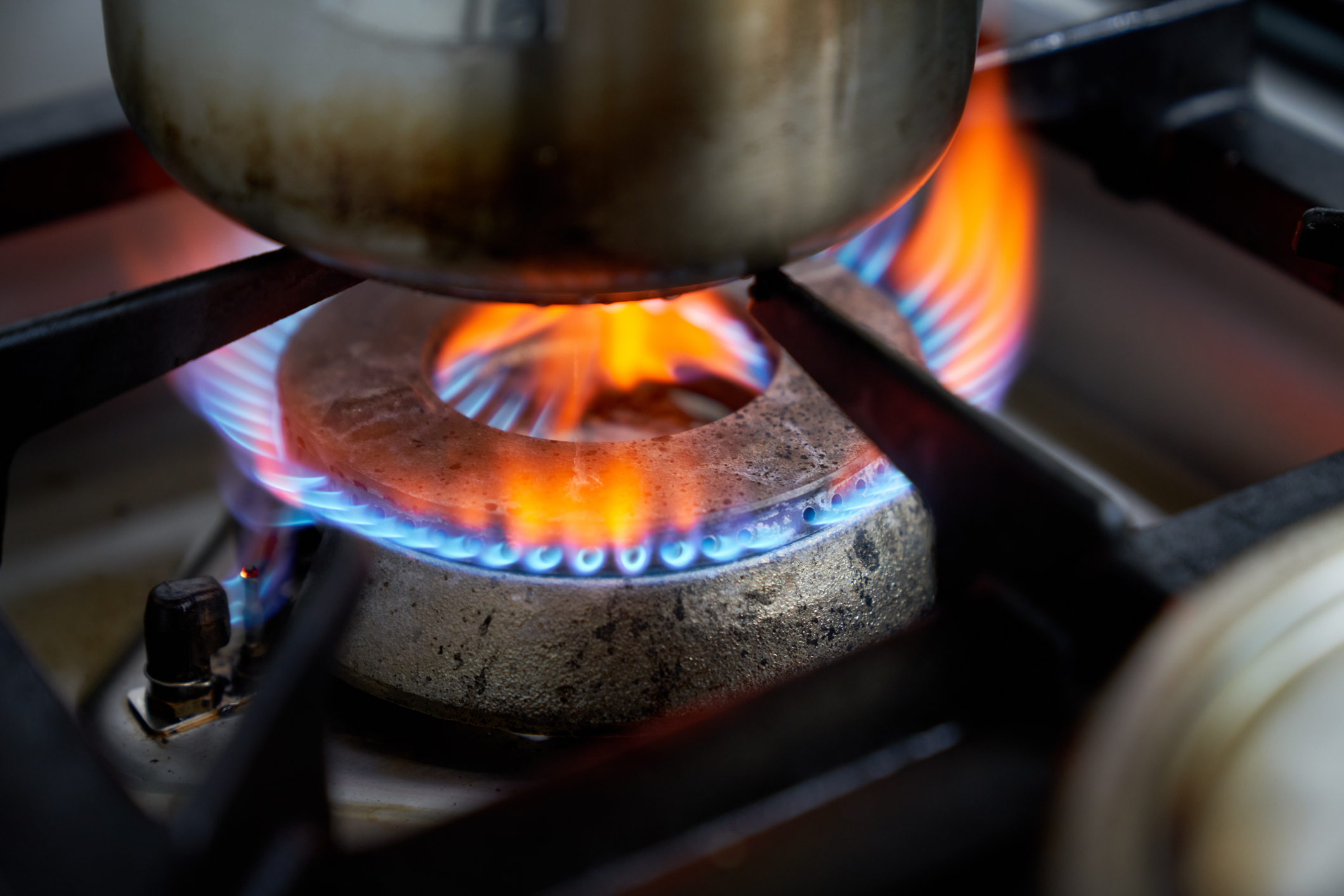 A close-up view of a gas stove burner flame.