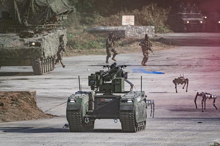 Drones, multipurpose unmanned ground vehicles and quadruped robots advance ahead of soldiers as a smoke-screening drone obscures the simulated enemy's view during an integrated unmanned combat demonstration at the Yangpyeong General Training Ground in Gyeonggi Province, Wednesday. Courtesy of Republic of Korea Army